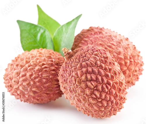 Photo: Lychee with leaves on a white background. Lychee with leaves on a white background.