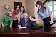 Executive signing a big contract with team of young women
