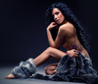 Gorgeous sexy brunette in fur posing indoors