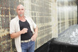 Handsome adult posing by an abstract wall