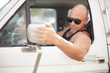 Man adjusting the vehicle mirror