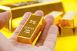 Hand hold gold bars