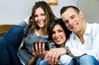 three friends having fun with a mobile phone