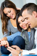 three friends having fun with a mobile phone