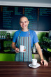 Photo: Bartender holding coffee cup Bartender holding coffee cup
