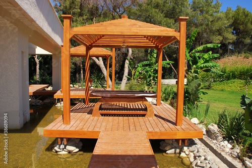 Photo: wood pavilion in tropical garden on summer resort wood pavilion in tropical garden on summer resort