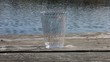 Clear Plastic Cup With Water Flowing Behind Clear Plastic Cup With Water Flowing Behind