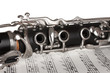close up detail of clarinet and notebook with notes close up detail of clarinet and notebook with notes