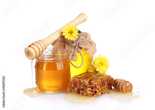 Photo: two jars of honey, honeycombs and wooden drizzler isolated two jars of honey, honeycombs and wooden drizzler isolated