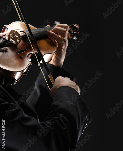 Photo: the violinist: Musician playing violin on dark background the violinist: Musician playing violin on dark background