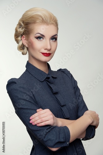 Photo: Retro woman in grey dress. Retro woman in grey dress.