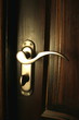 The iron doorhandle on the wooden doors close