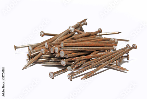 Photo: rusty nail on white background rusty nail on white background