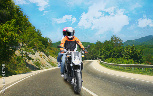 Photo: Two go on motorcycle on mountain road Two go on motorcycle on mountain road