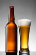 Beer in glass and bottle on white