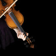 Photo: Young girl practicing the violin. Over black background. Young girl practicing the violin. Over black background.