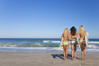 Three Beautiful Women Surfers In Bikinis With Surfboards Beach