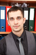Handsome male business executive behind a bookstand