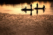 Silhouette Thai fisherman in big lake.