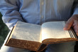 Photo: man reading 1904 German Bible in sunlight man reading 1904 German Bible in sunlight