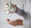 businessman emptying piggy bank businessman emptying piggy bank