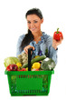 Young woman with shopping basket isolated on white