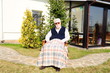 senior man sitting on garden of his house