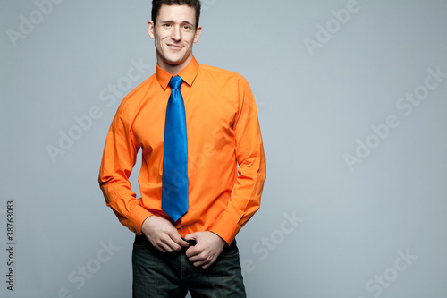 Photo: Happy handsome man in orange shirt. Happy handsome man in orange shirt.