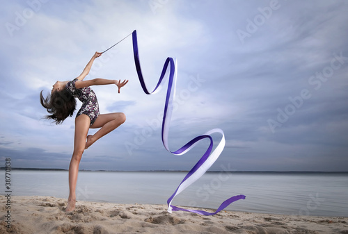 Photo: Young gymnast girl dance with ribbon Young gymnast girl dance with ribbon