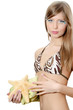 The young beautiful girl with a starfish isolated