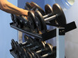 Two dumbbells being lifted from the rack.
