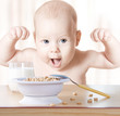 Happy baby meal: cereal and milk. Concept: healthy food makes ch
