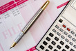 ink pen,calculator and payslip
