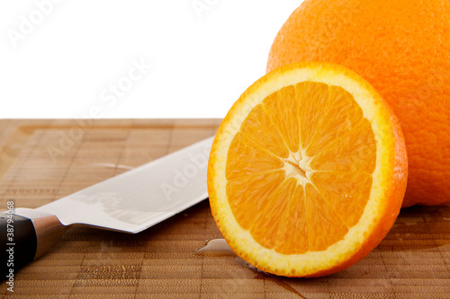 Photo: Orangen auf Holzbrett mit Messer Orangen auf Holzbrett mit Messer