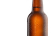 Beer bottle with water drops and frost isolated on white