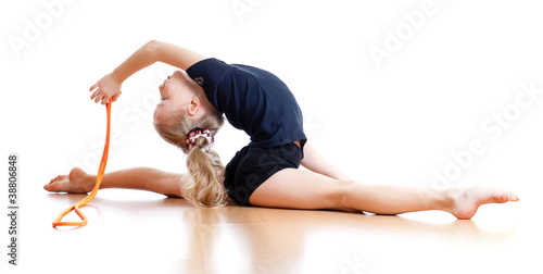 Photo: young girl doing gymnastics over white background young girl doing gymnastics over white background