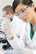 Chinese Female Woman Scientist With Test Tube In Laboratory