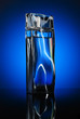 Designer’s bottle of a man perfume with reflection on blue bac Designer’s bottle of a man perfume with reflection on blue bac