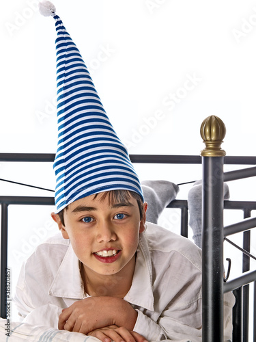 Photo: smiling boy in pajama and nightcap smiling boy in pajama and nightcap