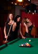 Group of happy girls playing in billiard