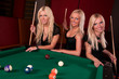 Group of happy girls playing in billiard