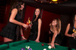 Group of happy girls playing in billiard