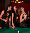 Group of happy girls playing in billiard