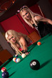 Happy girls playing in billiard