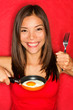 Foto: Woman making eggs for breakfast Woman making eggs for breakfast