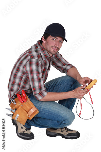 Photo: Man taking electrical reading Man taking electrical reading