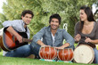 Three young musicians in park