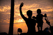 Silhouettes of mother and son at sunset