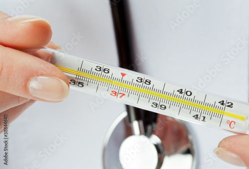 Photo: Doctor's hands holding thermometer Doctor's hands holding thermometer