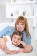 a 35 years old mother and her little girl lying down on a couch